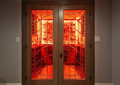 Home Wine Cellar in Naperville, Illinois glass doors inset cabinetry brown stain wine storage